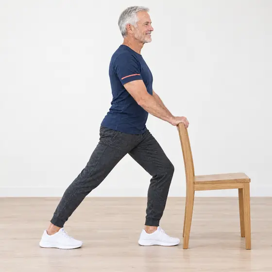 Calf Stretch: Hold the chair back, step one foot back.