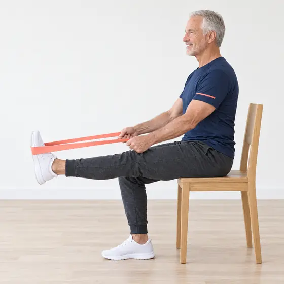 Band Hamstring Stretch: Sit tall, band looped around one foot.