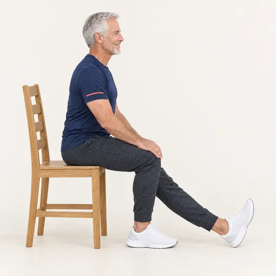 Hamstring Stretch: Sit near the front and straighten one leg, heel on the floor.