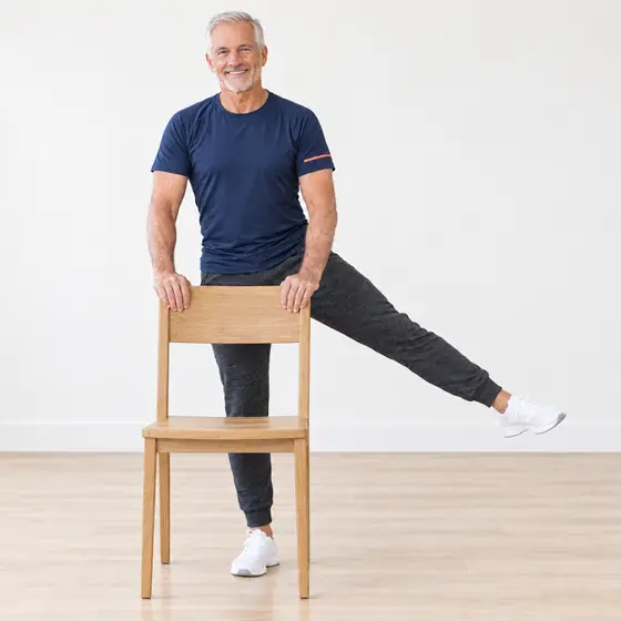 Side Leg Raise: Stand behind the chair, hands on the backrest.