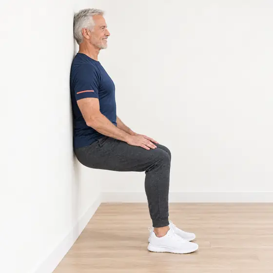Wall Sit: Stand with your back flat on the wall, feet a foot in front.