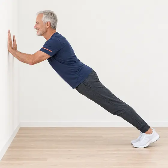 Wall Plank: Face the wall and place your forearms on it at shoulder height.