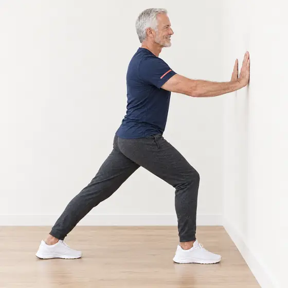 Calf Stretch: Face the wall, hands on it, one foot stepped back.